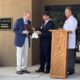 Baptist Golden Triangle CEO and administrator Rob Coleman and Chief Medical Officer James Martin present plaque to Dr. Reed